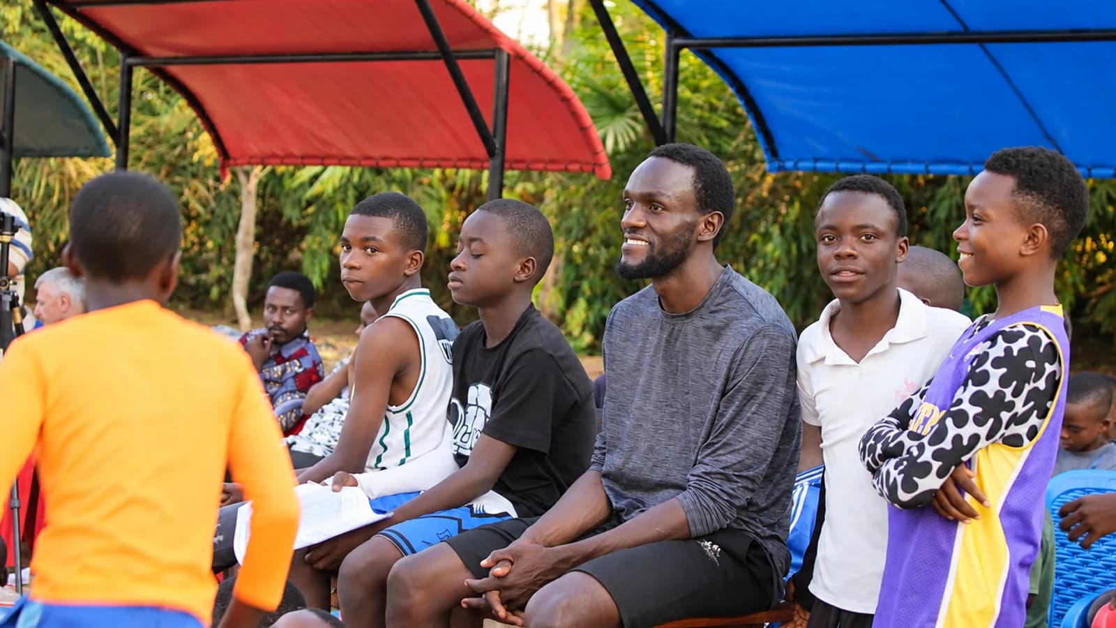 A KIVIDEA facilitator speaking during a community event in Kigoma